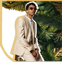 young chic blang guy in sunglassea with exhuberant plant background