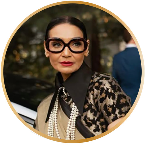 chic lady with large black eyeglasses, pearls and gold leopard top